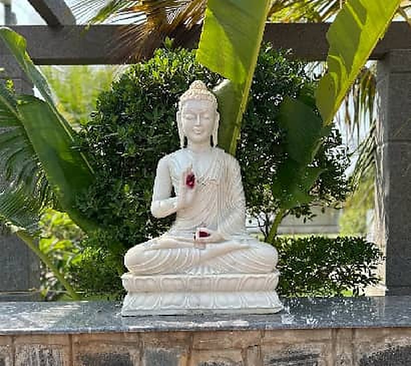 Garden corner with a white Buddha statue