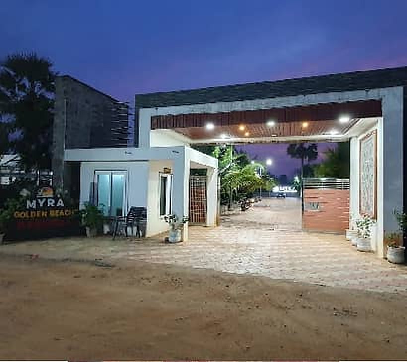Resort entrance gate lit at dusk in Chirala